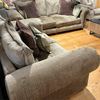 Fabric sofa with classic scrolled arms and decorative scatter cushions
