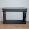 Narrow console table in black with ornate antique mirror details