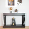 Elegant black table console with vintage scroll design
