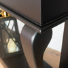Vintage-inspired black table console with antique mirror accents
