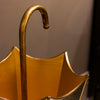 Durable Vela Umbrella Stand in gold adds class to any space
