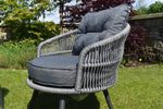 Comfortable garden armchairs with grey cushions
