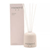 engaged reed diffuser and packaging on white background 