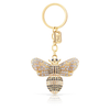 A gold-colored metal keyring in the shape of a bee with a sparkling, possibly gemstone-encrusted body.