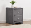 Gray nightstand with two drawers, a plant, and a book on a white wall background