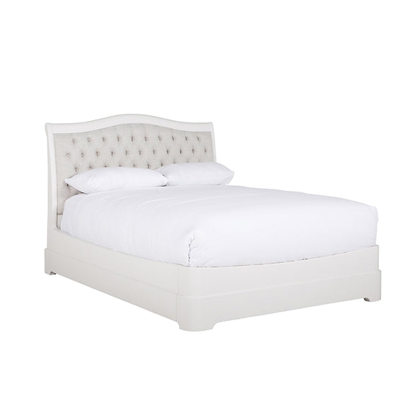 The Mabel Bed in Bone, King Size, showcasing its elegant and luxurious design. The upholstered headboard in a beautiful bone color adds a touch of sophistication to the bed, creating a serene and inviting sleeping space.