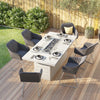 Create a cozy and stylish outdoor dining space with the Santorini Garden Rectangular Dining Table with Firepit, surrounded by chairs in a garden setting.