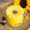 Sunflower Ceramic Oil Burner and Wax Warmer sitting on wicker table