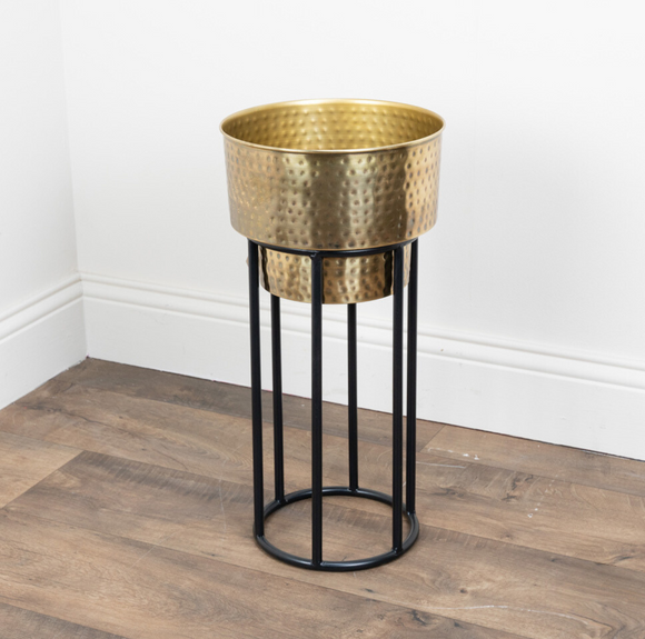 Decorative Metal Planter: The Salina Planter Medium, featuring a unique design with a hand-beaten metal surface, casting beautiful light reflections.