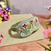 Floral Serenade Flower Velvet Eye Mask on bedside locker