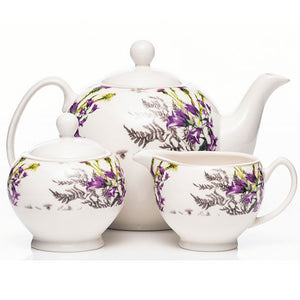 A visual showcasing the timeless elegance of the "Newgrange White Thistle 3 Piece Tea Set," featuring the teapot, creamer, and sugar bowl. Perfect for enhancing your tea moments with authentic craftsmanship.