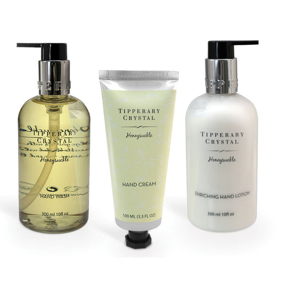 An image showcasing the Honeysuckle Hand Lotion, Hand Cream, and Soap Trio from Tipperary Crystal, ready to provide luxurious hand care and a delightful honeysuckle fragrance.
